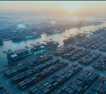 Person working on laptop with phone